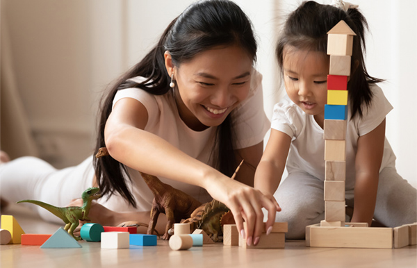 Parent and child playing with wooden blocks